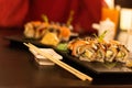 Various types of sushi on a black stone