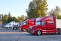 Various types of trucks in the parking lot next to the motorway. Truck stop Royalty Free Stock Photo