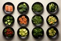 various types of vegetables sitting in small black bowls. Healthy snack foods with small bowls. Small breakfast bowls