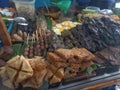 Various typical Indonesian side dishes including tofu, tempeh, egg satay, and fried beef lungs Royalty Free Stock Photo