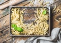 Various uncooked Italian pasta in wooden tray with basil leaves Royalty Free Stock Photo