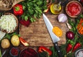 Various uncooked vegetables, herbs and spices for healthy cooking, cutting board and chef knife on wooden table, top view. Royalty Free Stock Photo