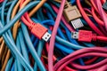 Various USB cables in vibrant colors lie intertwined on a surface, highlighting their Royalty Free Stock Photo
