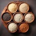 Various varieties: brown coarse rice and white thai jasmine rice in a wooden bowl