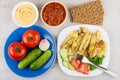 Various vegetables, bowls with sauces and baked potatoes Royalty Free Stock Photo