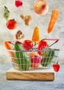 Various vegetables and fruits flying and falling into a supermarket basket standing on a wooden podium. Abundance and delivery Royalty Free Stock Photo