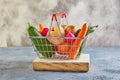 Various vegetables and fruits lying in a supermarket basket on a wooden podium Royalty Free Stock Photo