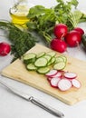 Various vegetables: garden radish, cucumbers, onions on a white Royalty Free Stock Photo