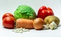 various vegetables laid out on a white background.