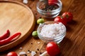 Various vegetables, seasoning and spicies around blank plate on rustic wooden background, top view Royalty Free Stock Photo