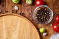 Various vegetables, seasoning and spicies around blank plate on rustic wooden background, top view Royalty Free Stock Photo