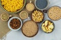 Various vegetarian organic foods in bowls. Wheat, poppy seeds, soy, raisins, nuts, coffee, pasta. Top view.