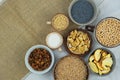 Various vegetarian organic foods in bowls. Wheat, poppy seeds, soy, raisins, nuts, coffee, pasta. Top view. Copy space.