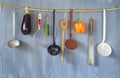 Various vintage kitchen utensils and vegetables on a rustic wall Royalty Free Stock Photo