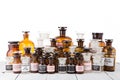 Various vintage pharmacy bottles on wooden table in pharmacy