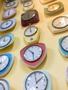 Various of vintage wall clocks hanging against light yellow wall Royalty Free Stock Photo