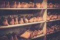 Various of vintage wooden shoe lasts in a row on the shelves.