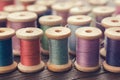 Various vintage wooden spools of multicolored threads