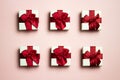 A various white gift boxes with red ribbon over the pink background. Royalty Free Stock Photo