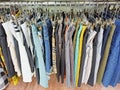 Various women\'s fashion pants hanging on the rack in a retail store.