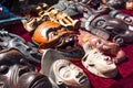 Various wooden Asian or African masks on sale at flea market, outdoors