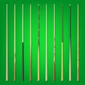 Various wooden billiard cues on green background. Snooker sports equipment. Vintage pool cue. Active recreation and