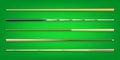 Various wooden billiard cues on green background. Snooker sports equipment. Vintage pool cue. Active recreation and
