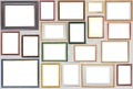 Various wooden photo frames hang on a wall