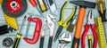 Various working tools on grey table background. drills, wrenches, bolts, screws, clamps