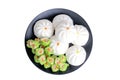 Varitirs steamed stuff bun and green chinese steamed dumpling with pork served in black disk Royalty Free Stock Photo