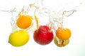 Varius fruits apple pear lemon and clementine splash in water in Royalty Free Stock Photo