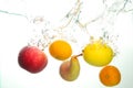 Varius fruits apple pear lemon and mandarine splash in water in