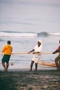 Fishing net with many fishermen on backside. Odayam beach, Varkala, India