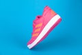 Varna , Bulgaria - AUGUST 13, 2019 : ADIDAS ALTA SPORT pink shoe, on blue background. Product shot. Adidas is a German corporation