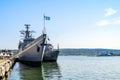 Two large gray modern warships with flags moored at the pier in the Varna seaport on a sunny summer day. Naval exercises, attack