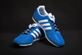 Varna , Bulgaria - MARCH 12, 2017 : ADIDAS V RACER running shoe on dark background. Product shot. Adidas is a German corporation t