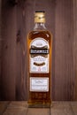 VARNA, BULGARIA - MARCH 16, 2020: Bushmills whiskey bottle on wooden background. Bushmills whiskey distillery was founded in 1784