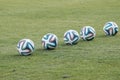 Varna, BULGARIA - MAY 30, 2015: 5 official FIFA 2014 World Cup balsl (Brazuca) on the grass. Royalty Free Stock Photo