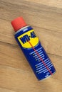 VARNA, BULGARIA - MAY 19, 2022: WD-40 on wooden background. Multi use product protects metal from rust and corrosion