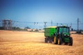 Varna Region, Bulgaria - June 20, 2015: John Deere 6115R tractor with the trailer