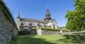 Varnhem Abbey Church with ruins or overgrown arches and graveyard