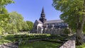 Varnhem Abbey Church with ruins or overgrown arches and graveyard