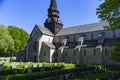 Varnhem Abbey Church with ruins or overgrown arches and graveyard