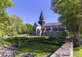 Varnhem Abbey Church with ruins or overgrown arches and graveyard