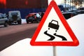 Varning sign for slippery road ahead Royalty Free Stock Photo