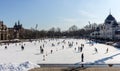 Skating people at ice rink in Varosliget park on sunny day. Winter sport and relax.