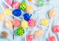 Varrious colourful lollipops on a wooden table.