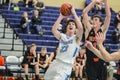 Varsity high school basketball player goes up for a basket; guarded by opponent. Royalty Free Stock Photo