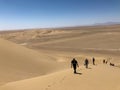 Varzaneh desert, Iran - 08/22/2019. Hiking up the dune. Dunes in Iran.