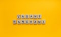 Vasant Panchami, a minimalistic banner with an inscription in wooden letters Royalty Free Stock Photo